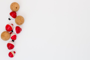 Cluster of old fishing bobbers on white background © Tammy