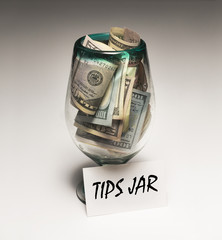 $50 bills and $100 bils in tips jar