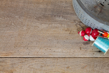 antique minnow bucket on barn wood with hooks & bobbers