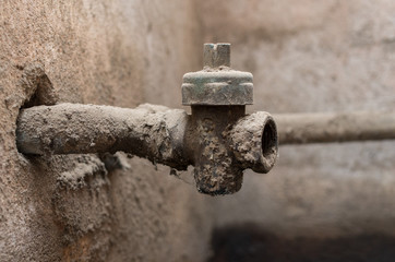 Old and dirty water tap