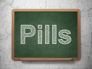 Health concept: text Pills on Green chalkboard on grunge wall background, 3D rendering