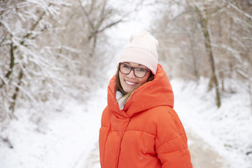 Obraz premium Woman with toothy smile relaxing outdoor in winter