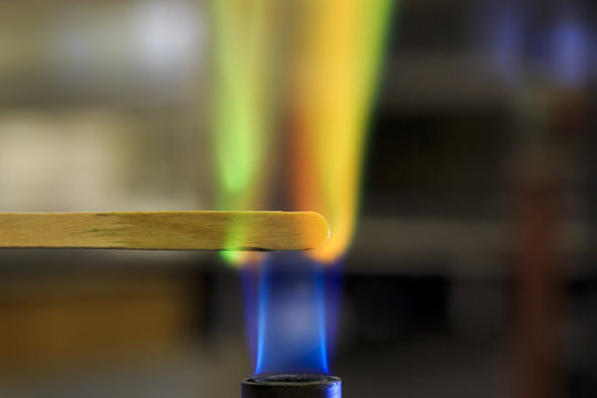 Copper solution burning on a wooden splint in a bunsen burner flame.