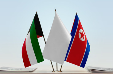 Flags of Kuwait and North Korea with a white flag in the middle