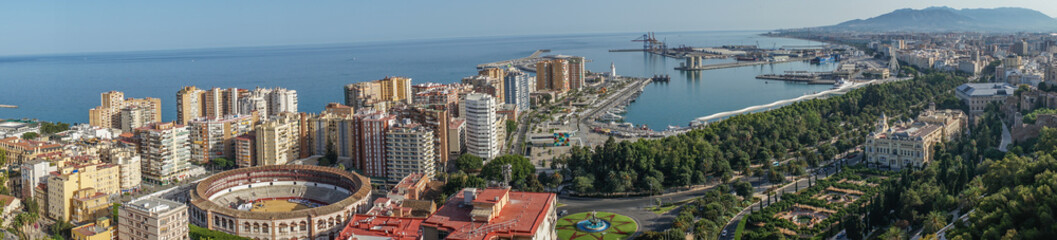 Panorama City skyline and harbour, sea port, bullring of Malaga overlooking the sea ocean in...