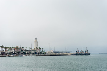 Lighthouse and ships along the coastline at Malaga, Spain, Europe