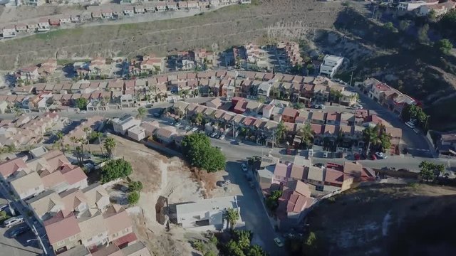 erial footage of a residential area in Tijuana, Baja California, Mexico during a Santana, local name for sand storm. High density of houses in a desert area, dusty sky.