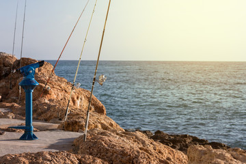 Fishing rod with windlasses on pier mirador at sunset in mediterranean european