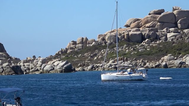 Sailing yachts and motor boats anchorage near Lavezzi Islands archipelago