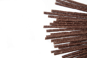Chocolate Flavoured Stick Candy in a fan pattern with copy space