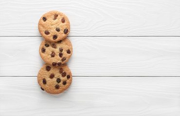 biscuits with raisins on a white wooden background