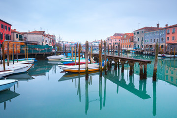 Fototapeta premium Wintertime of the rainy weather. Emerald water in the canals at low tide. Less known are not tourist destinations in the Castello-Arsenale. Venice. Italy.
