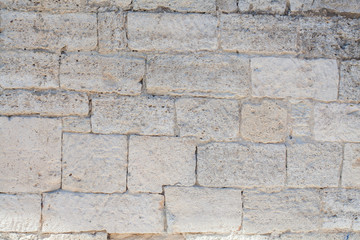 The wall is lined with stones. Building with cobblestones. Background of stones.