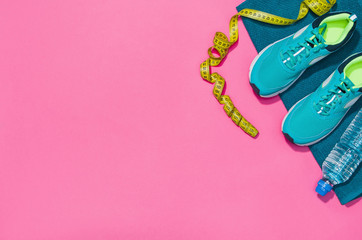 Fitness accessories, healthy and active lifestyles concept background with copy space for text. Products with vibrant, punchy pastel colours and frame composition. Image taken from above, top view.