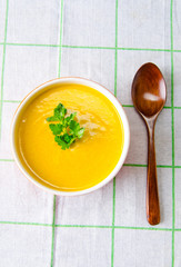Carrot soup served on the table in bowl