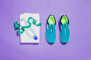 Fitness accessories, healthy and active lifestyles concept background with copy space for text. Products with vibrant, punchy pastel colours and frame composition. Image taken from above, top view.