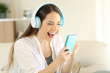 Excited girl finding offers online listening to music