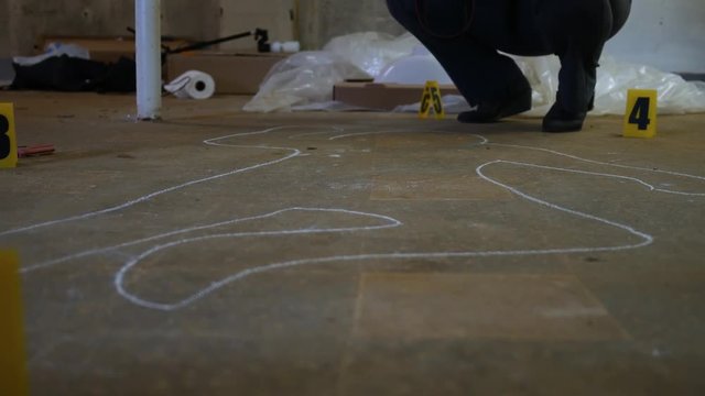 Sliding past a chalk outline at an active police crime scene for a homicide case