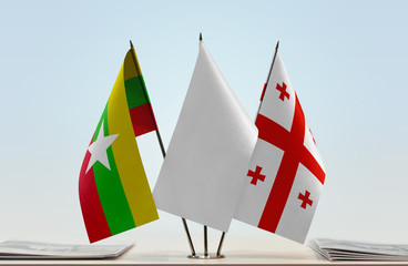 Fototapeta na wymiar Flags of Myanmar and Georgia with a white flag in the middle