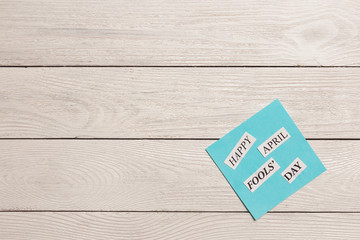 April Fools Day printed phrase on wooden background
