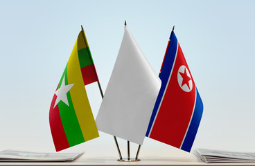 Flags of Myanmar and North Korea with a white flag in the middle