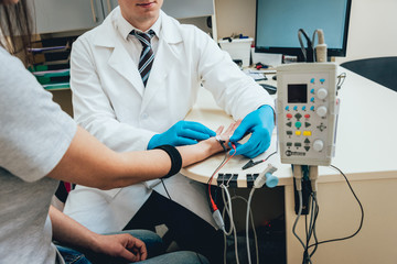 Patient nerves testing using electromyography. EMG