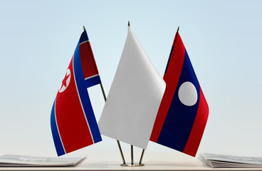 Flags of North Korea and Laos with a white flag in the middle