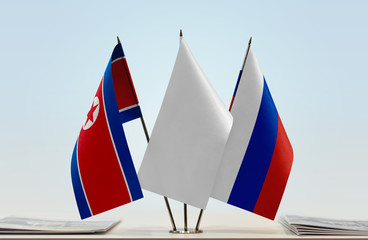 Flags of North Korea and Russia with a white flag in the middle