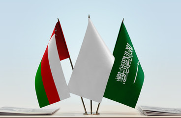 Flags of Oman and Saudi Arabia with a white flag in the middle