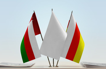 Flags of Oman and South Ossetia with a white flag in the middle