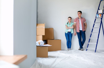 Portrait of young couple moving in new home. Young couple