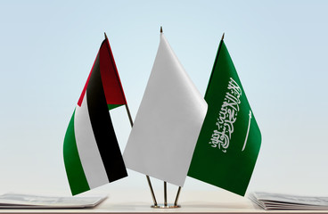 Flags of Palestine and Saudi Arabia with a white flag in the middle