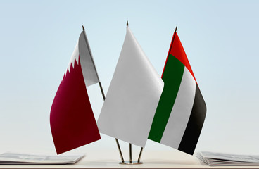 Flags of Qatar and UAE with a white flag in the middle