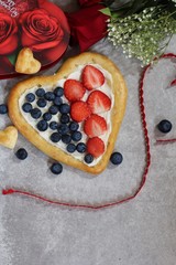 Homemade Heart shaped Fruit dessert Pizza with berries / Valentines day food