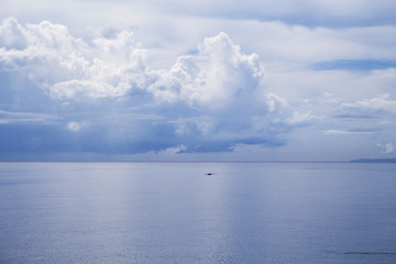 Obraz premium Sea and sky double landscape. Seashore view with fishing boat.