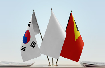 Flags of  South Korea and East Timor with a white flag in the middle