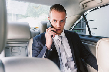Businessman use smartphone in the car