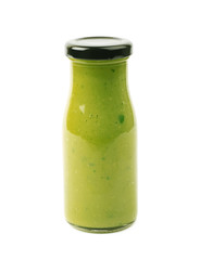 Green sauce in a bottle isolated