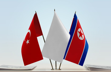 Flags of Turkey and North Korea with a white flag in the middle
