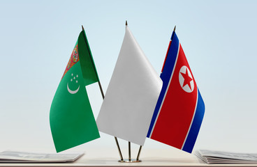 Flags of Turkmenistan and North Korea with a white flag in the middle