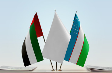 Flags of UAE and Uzbekistan with a white flag in the middle