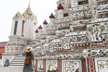 Obraz premium Woman tourist is traveling and sightseeing inside Wat Arun temple in Bangkok, Thailand.