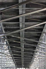 Fototapeta premium Architectural Detail of Mucem with metal pipe scaffolding and a metal walkway photographed from below.