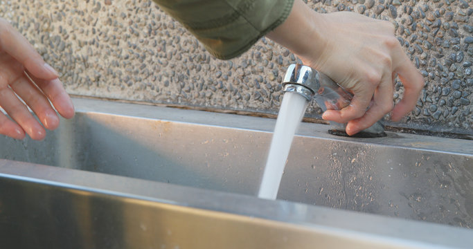Woman washing hand at outdoor