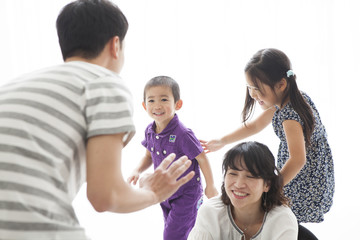 お父さん、お母さんと楽しそうに遊ぶ、男の子と女の子。