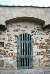 Fototapeta na wymiar green door with cobblestone