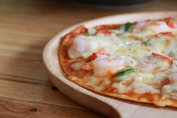 Close up sea food pizza on wooden tray