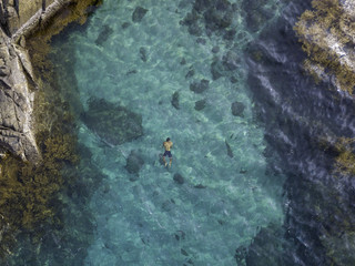 Fototapeta na wymiar drone view of a man swimming