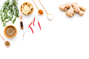 Seasoning background. Dry spices near ginger, garlic, rosemary, chili on white background top view copy space
