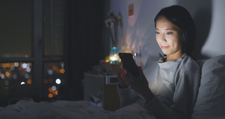 Woman use of smart phone at night